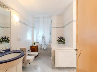 a bathroom with a sink and a toilet and a tub at Apartment Relax tra i Monti by Interhome in Livo