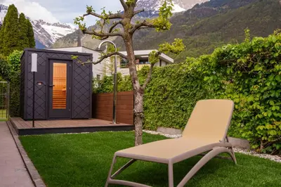a chair in a yard with a tiny house at Villa Ilaria in Lagundo