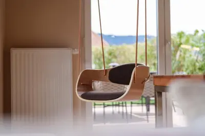 a couple of chairs hanging in front of a window at Villa Ilaria in Lagundo