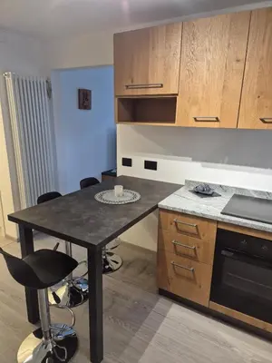 a kitchen with a table and chairs in a room at Casa Celeste Dolomiti in Frassenè
