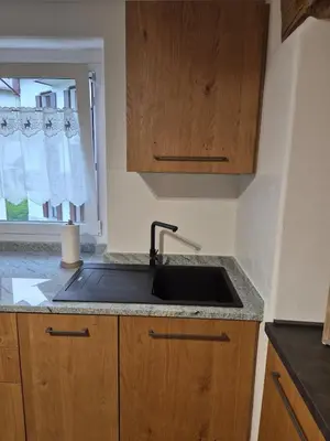 a kitchen counter with a sink and a window at Casa Celeste Dolomiti in Frassenè