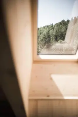 a window with a view of a forest at Zalnerhof Urlaub am Bauernhof in Luson