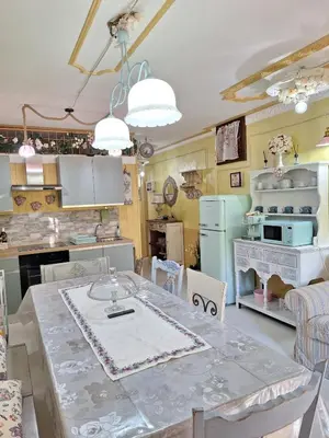 a kitchen with a table and a stove and a refrigerator at Alessandra's House Mountain in Masarè