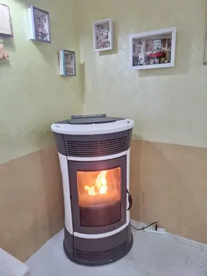 a fireplace in a room with a fire in it at Alessandra's House Mountain in Masarè