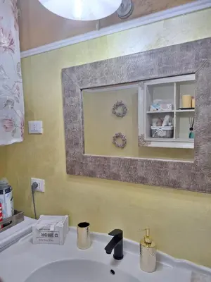 a bathroom sink with a mirror above it at Alessandra's House Mountain in Masarè