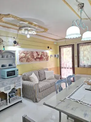a living room with a couch and a table at Alessandra's House Mountain in Masarè