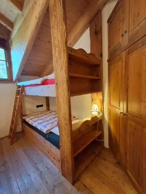 a bedroom with two bunk beds in a cabin at Maso Tre Cucù by Go New Location in Cavalese