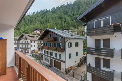 a balcony with a view of a group of buildings at Suite Civetta in Masarè