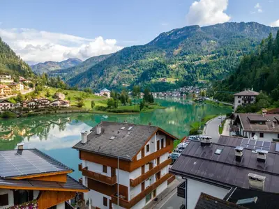 a view of a river with houses and mountains at Suite Civetta in Masarè