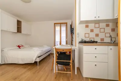 a small room with a bed and a desk in it at Suite Civetta in Masarè