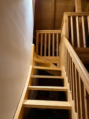 an overhead view of a wooden staircase in a house at Elegante Appartamento in Campitello fi Fassa in Campitello di Fassa