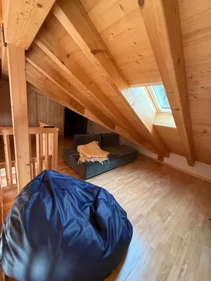 an attic room with a large blue bean bag at Elegante Appartamento in Campitello fi Fassa in Campitello di Fassa