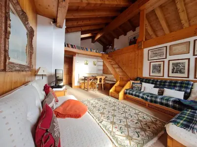 a living room with a couch and a table at Villa Allegra Mountain view in Cortina dʼAmpezzo