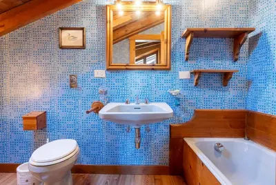 a bathroom with a toilet and a sink and a tub at Villa Allegra Mountain view in Cortina dʼAmpezzo