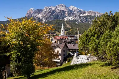 a town on a hill with mountains in the background at Villa Allegra Mountain view in Cortina dʼAmpezzo