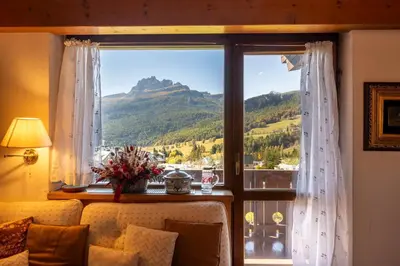 a room with a window with a view of a mountain at Villa Allegra Mountain view in Cortina dʼAmpezzo