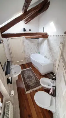 a bathroom with two sinks and a bath tub at Dolomites Luxury Penthouse in Agordo