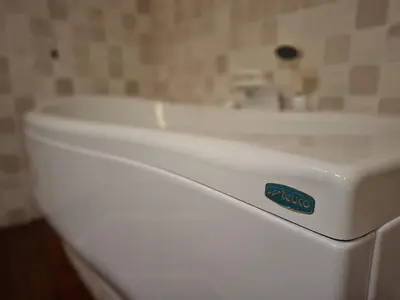 a white toilet in a bathroom with a sink at Dolomites Luxury Penthouse in Agordo