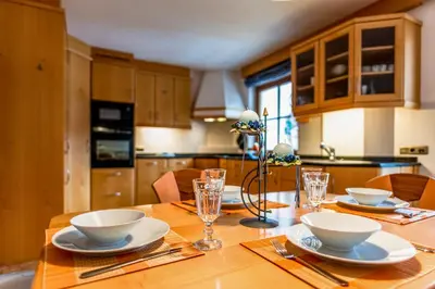 a kitchen with a wooden table with dishes on it at Apartment Vernel in Santa Cristina in Val Gardena