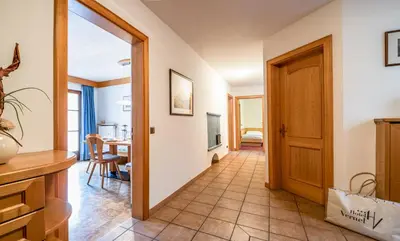 a hallway with a door leading to a dining room at Apartment Vernel in Santa Cristina in Val Gardena