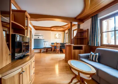 a living room with a couch and a tv and a table at Apartment Vernel in Santa Cristina in Val Gardena