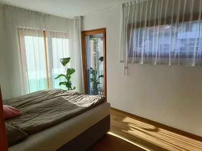 a bedroom with a bed and a window at Villa Ehrenburg - Private Apartments in Merano