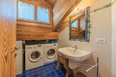 a small room with a bench and a wall at Chalet Dolomites Heart in Feder