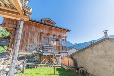 an image of a house with mountains in the background at Chalet Dolomites Heart in Feder