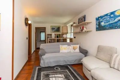 a living room with a bed and a couch at Appartamento al Rio in Moena