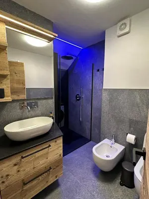 a bathroom with a sink and a tub and a toilet at Cèsa Sabrina in Moena