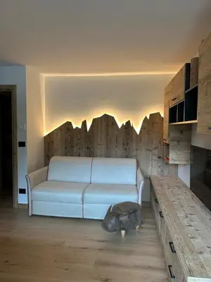a living room with a couch and a table at Cèsa Sabrina in Moena