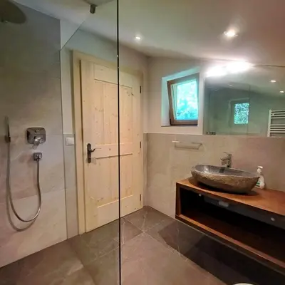 a bathroom with a sink and a glass shower at Almliesl WELS-424 in Monguelfo
