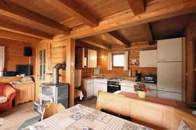 a kitchen in a log cabin with a stove at Almliesl WELS-424 in Monguelfo
