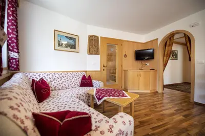 a living room with a couch and a table at Apartments Miara in Santa Cristina in Val Gardena