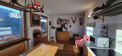 a living room with a couch and a table at Condominio de Rocia in Moena