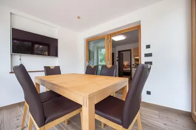 a dining room with a wooden table and chairs at Apartments Cesa Ploner in Ortisei