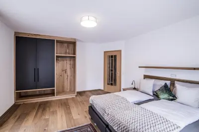 a bedroom with two beds and a tv at Erika Suites & Lofts Chalet in Stanghe