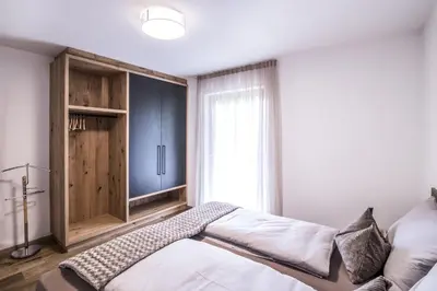 a bedroom with a bed and a large window at Erika Suites & Lofts Chalet in Stanghe