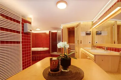 a bathroom with a sink and a tub at Apartments Rondula in Santa Cristina in Val Gardena