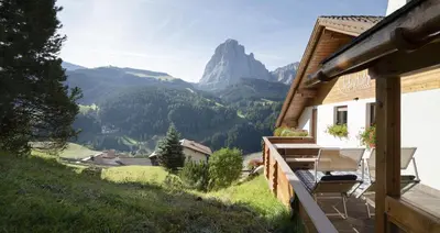a balcony of a house with a view of mountains at Apartments Rondula in Santa Cristina in Val Gardena