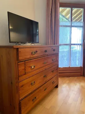 a wooden dresser with a television on top of it at Platzlhof in Appiano sulla Strada del Vino