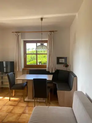 a living room with a table and chairs and a window at Platzlhof in Appiano sulla Strada del Vino