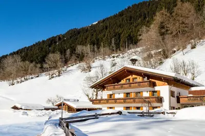 a building in the snow with a mountain at Ferienhaus Daniel in Racines