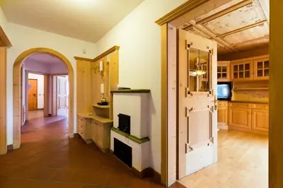 a kitchen with a fireplace and an open door at Ferienhaus Daniel in Racines