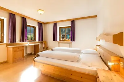 a bedroom with two beds in a room with windows at Ferienhaus Daniel in Racines