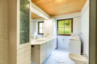 a white bathroom with two sinks and a shower at Ferienhaus Daniel in Racines