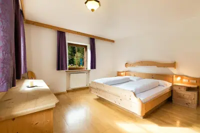 a bedroom with a wooden bed and a window at Ferienhaus Daniel in Racines