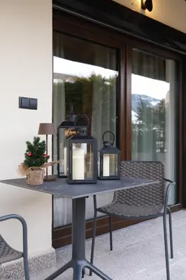 a table with two candles on top of it at GARDEN SUITE appartment in Valdaora di Sopra