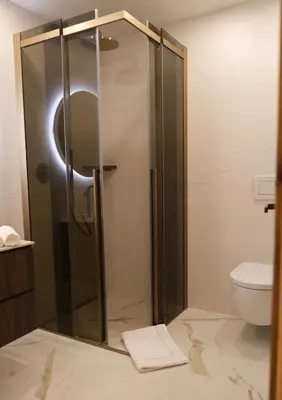 a shower stall in a bathroom with a toilet at GARDEN SUITE appartment in Valdaora di Sopra