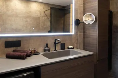 a bathroom with a sink and a mirror at GARDEN SUITE appartment in Valdaora di Sopra